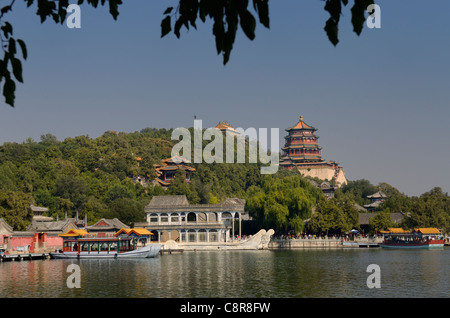 Marble Boat among other ferries on Kunming Lake with Buddhist Fragrance Pavilion on Longevity Hill Summer Palace Beijing Peoples Republic of China Stock Photo