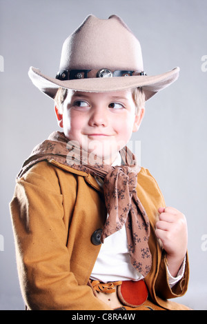 A young cowboy child with fist ready to fight looking to right Stock Photo