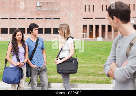 Student looking at one of his classmates talking Stock Photo