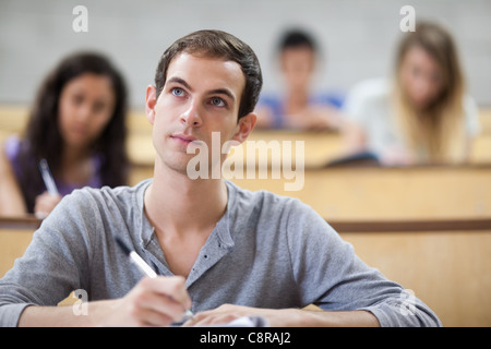Students taking notes in an amphitheater Stock Photo