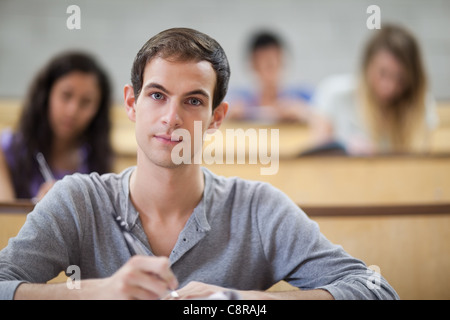 College students taking notes in an amphitheater Stock Photo