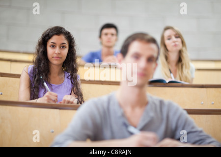 Focused students listening during a lecture Stock Photo