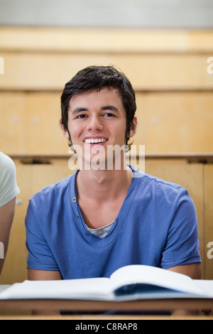 Portrait of a student posing with a book Stock Photo - Alamy