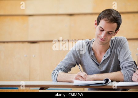 young male student writing notes in the classroom Stock Photo - Alamy