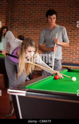 Portrait of young friends playing snooker Stock Photo