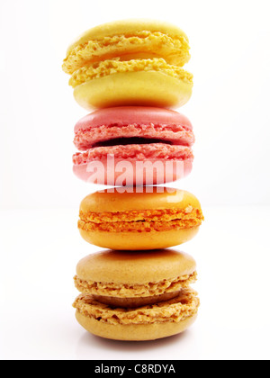stack of lemon, strawberry, apricot and praline macaroons with a white background Stock Photo