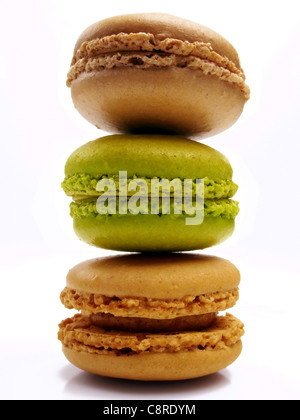 Stack of praline, coffee and pistachio macaroons with a white background Stock Photo