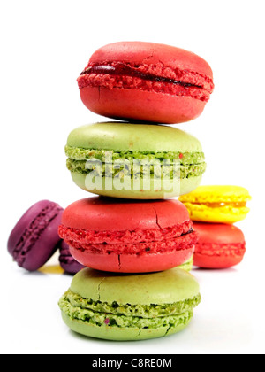 stack of strawberry and pistachio macaroons with some macaroons behind and a white background Stock Photo