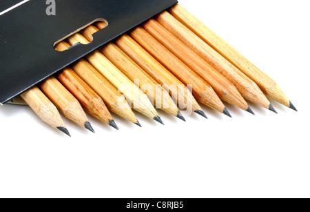 The yellow ground pencils in a black box lie is isolated on a snow-white backgr Stock Photo