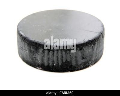 Black old hockey puck isolated on white background Stock Photo