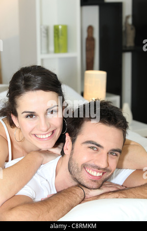 Young couple cheerful laid in bed Stock Photo