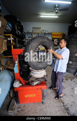 Africa, Tunisia, Nabeul. Local tunisian mechanic while repairing a tyre puncture on a Michelin XS sand tyre. Stock Photo