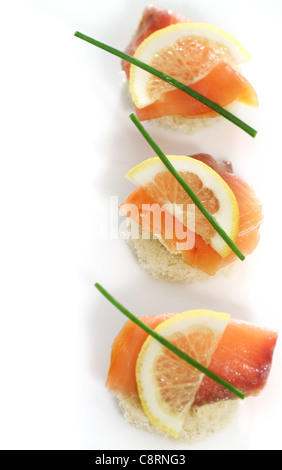 Extreme close-up of smoked salmon served with lemon, cheese and onion Stock Photo