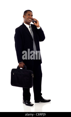 Thoughtful black business looking up at copyspace while talking on the mobile phone isolated over white background Stock Photo