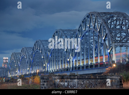 The railway riveted bridge across Daugava river in Riga, Latvia. Stock Photo