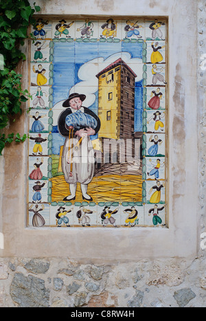 Decorative tiles on the walls of Valldemossa in Mallorca / Majorca. The  tiles feature images from the life of Santa Catalina Stock Photo