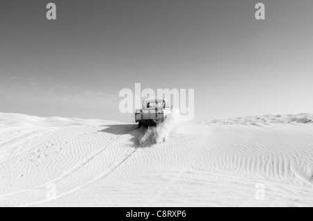 Africa, Tunisia, nr. Tembaine. Desert traveller driving his 1964 Land Rover Series 2a Truck Cab through a sandfield close to ... Stock Photo