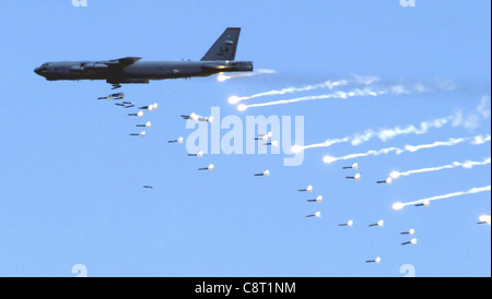 NELLIS AIR FORCE BASE, Nev. -- A B-52 Stratofortress from Barksdale Air Force Base, La., drops live ordnance over the Nevada Test and Training Range near here May 12 during an Air Force firepower demonstration. The demonstration showcases the Air Force's air and space capabilities. Stock Photo