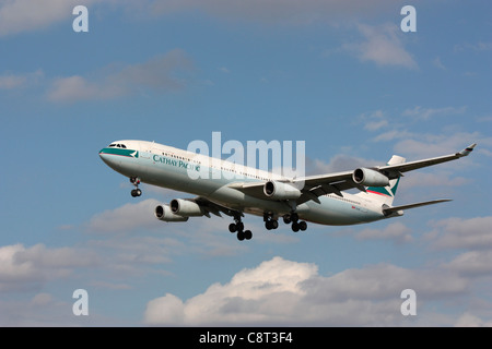 Cathay Pacific Airways Airbus A340-300 shortly before landing. Off-centre composition with copy space. Stock Photo