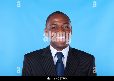 African businessman smiling with a blue background Stock Photo