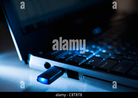 Studio shot of flash drive in laptop Stock Photo