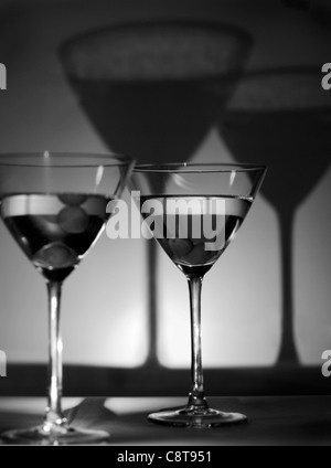 Martini glasses with olives, cast shadows, black and white Stock Photo