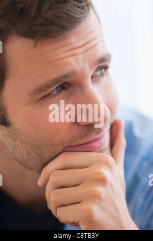 USA, New Jersey, Jersey City, Portrait of young man with hand on chin Stock Photo