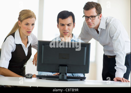 USA, New Jersey, Jersey City, Business team looking at computer Stock Photo