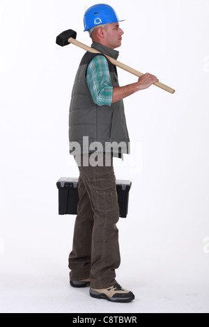 craftsman holding a hammer and a toolbox Stock Photo