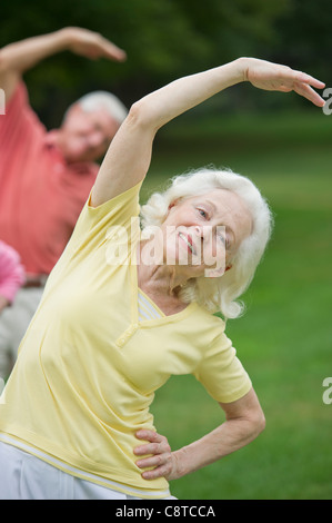 USA, New York State, Old Westbury, Seniors stretching in park Stock Photo
