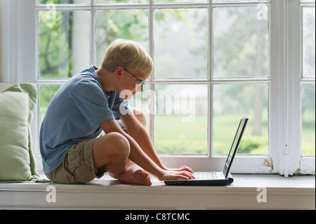 USA, New York State, Old Westbury, Boy using laptop at home Stock Photo