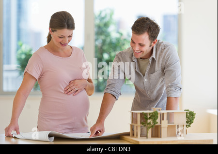 USA, New Jersey, Jersey City, Young couple looking at blueprints Stock Photo