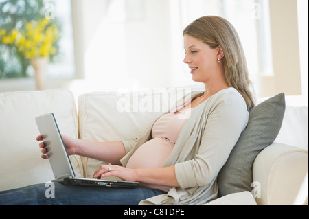 USA, New Jersey, Jersey City, Young pregnant woman doing using laptop Stock Photo
