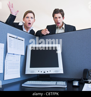 USA, New Jersey, Jersey City, Office workers shouting in office cubicle Stock Photo