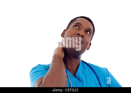 African American healthcare worker with hand on neck looking at copy space Stock Photo