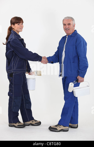 Two painter shaking hands. Stock Photo