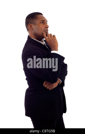Blackc businessman standing on white background, looking off into distance Stock Photo