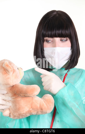 Doctor scolding a teddy bear Stock Photo