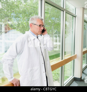 USA, Utah, Ogden, USA, Utah, Ogden, Doctor using mobile phone while standing in hospital corridor Stock Photo