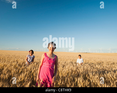USA, Oregon, Wasco, Girls and boy standing in wheat field Stock Photo