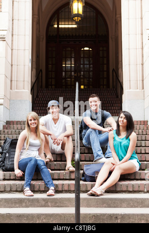 USA, Washington, Seattle, Portrait of four college students sitting on steps Stock Photo