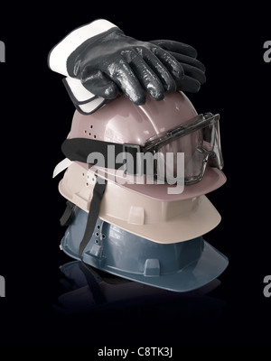 Hardhats, gloves and goggles on black Stock Photo