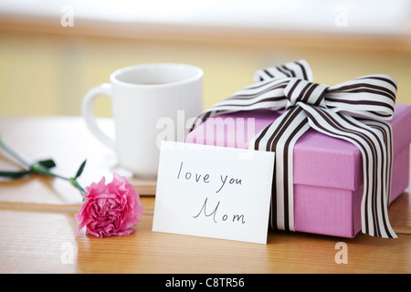 Wrapped Gift Box And Coffee Mug On Desk Stock Photo