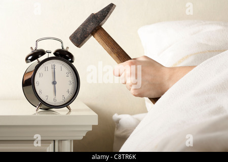 Crushing Alarm Clock with Hammer Stock Photo