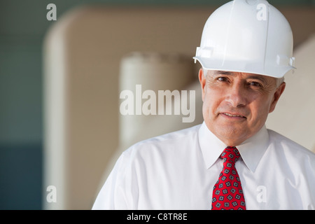USA, New Mexico, Santa Fe, Portrait of senior man wearing tie and hardhat Stock Photo