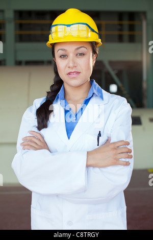 USA, New Mexico, Santa Fe, Portrait of woman wearing lab coat and hardhat Stock Photo