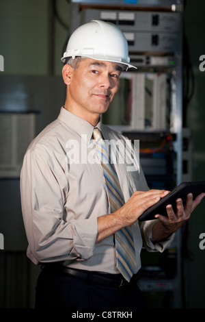 USA, New Mexico, Santa Fe, Portrait of male technician wearing hardhat Stock Photo