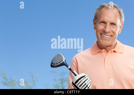 USA, Arizona, Scottsdale, Portrait of senior man holding golf club Stock Photo