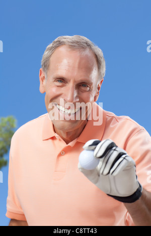 USA, Arizona, Scottsdale, Portrait of senior man holding golf ball Stock Photo