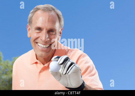 USA, Arizona, Scottsdale, Portrait of senior man holding golf ball Stock Photo